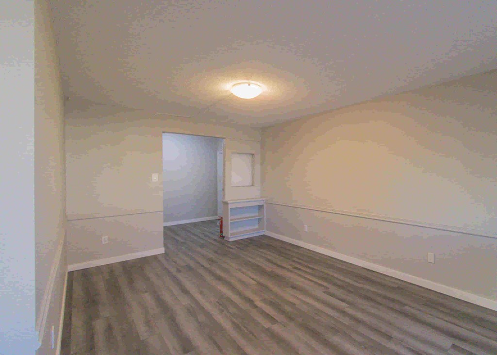 a room with white walls and a wooden floor