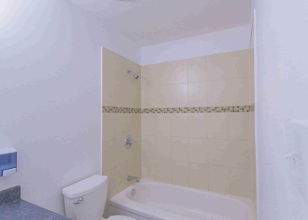 a bathroom with a tub and a toilet