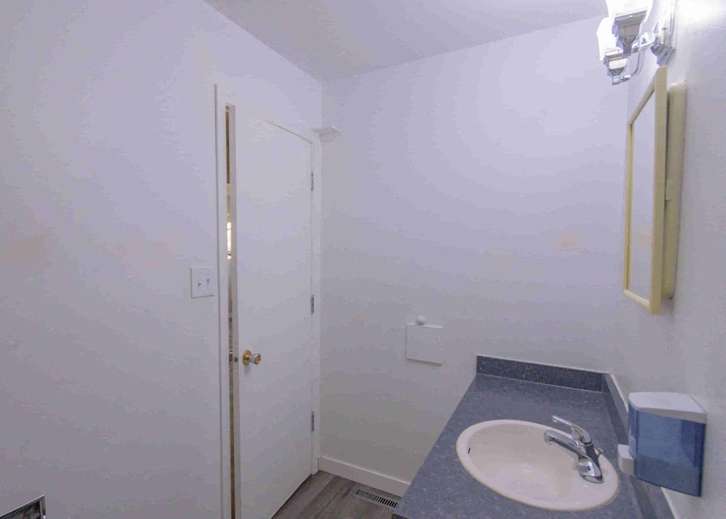 a small bathroom with a sink and a shower