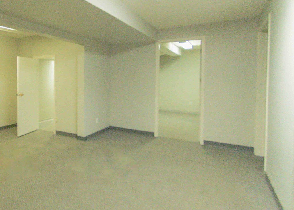 an empty room with white walls and white doors