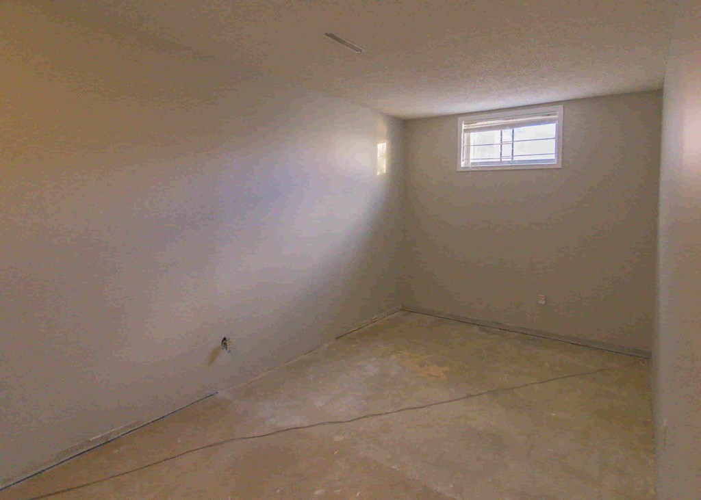 a room with white walls and a window in it