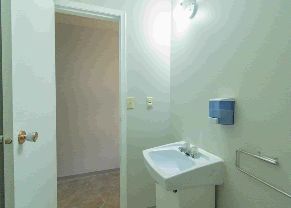 a small bathroom with a sink and a mirror