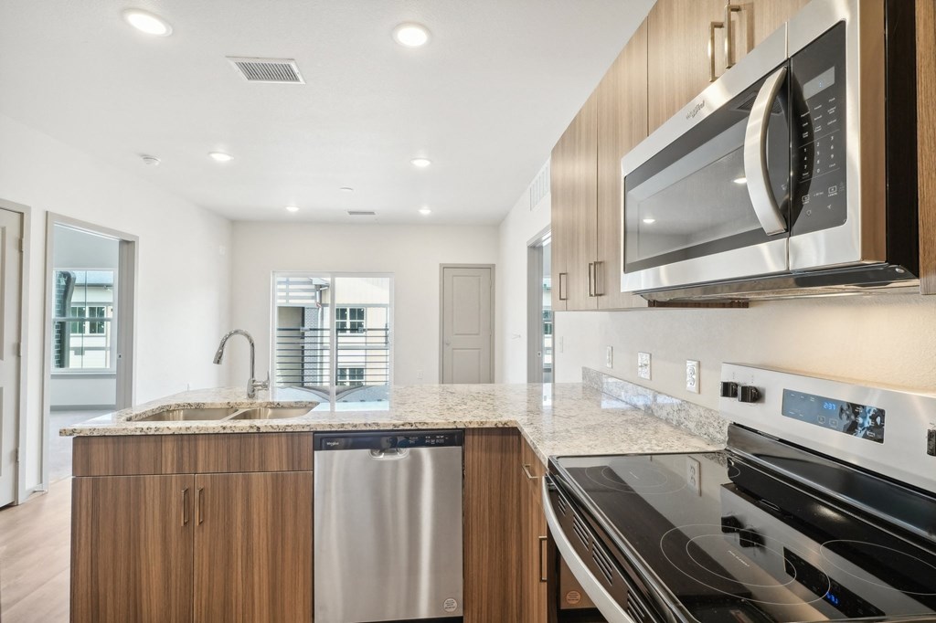 a modern kitchen with stainless steel appliances and granite counter tops