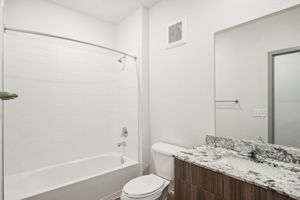 the preserve at ballantyne commons apartment bathroom with tub and toilet and sink