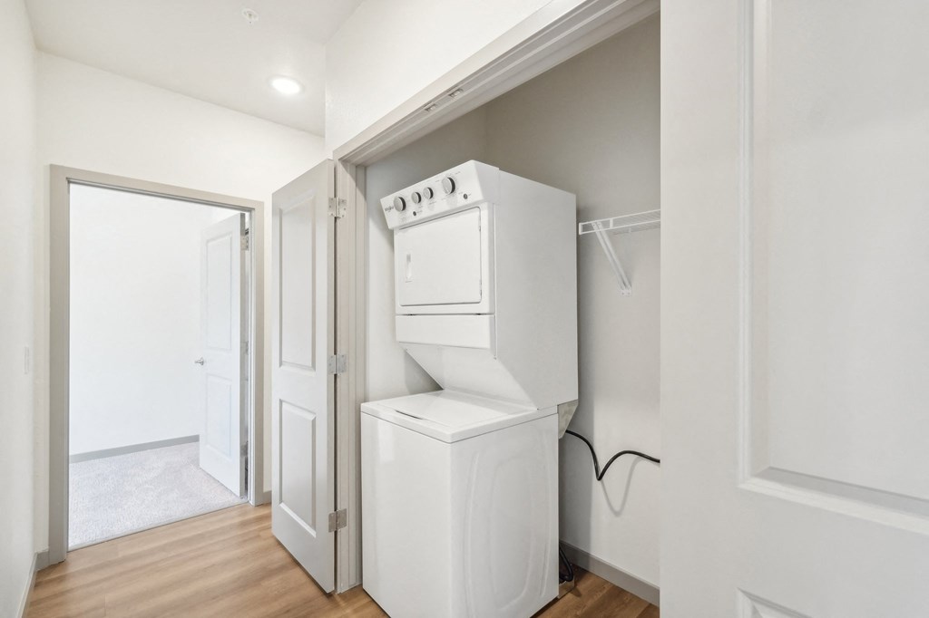 a white laundry room with a white washer and dryer