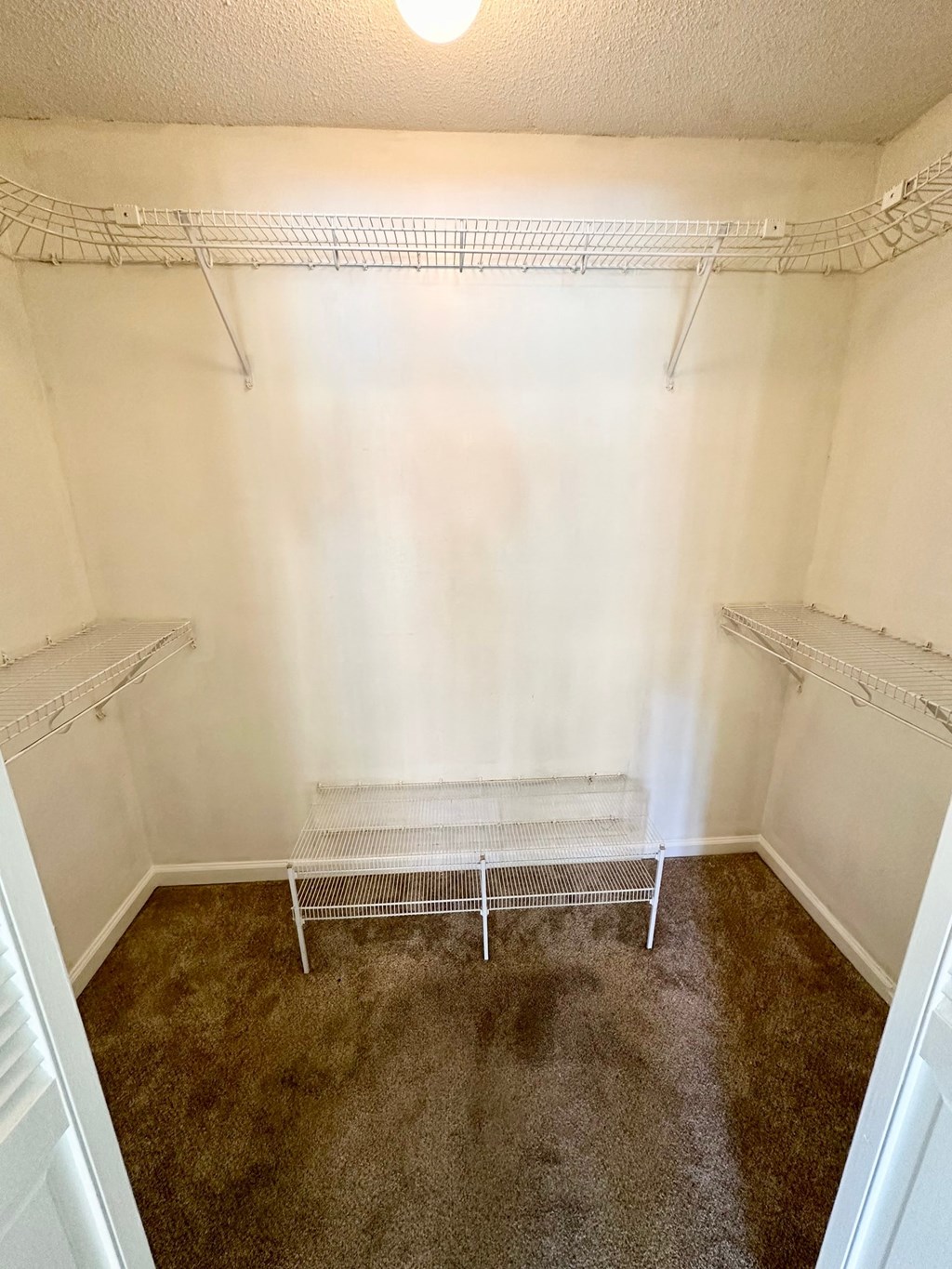 a empty closet in a bathroom with empty shelves