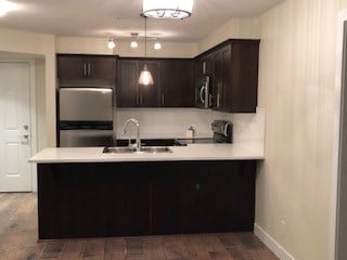 a kitchen with a sink and a refrigerator