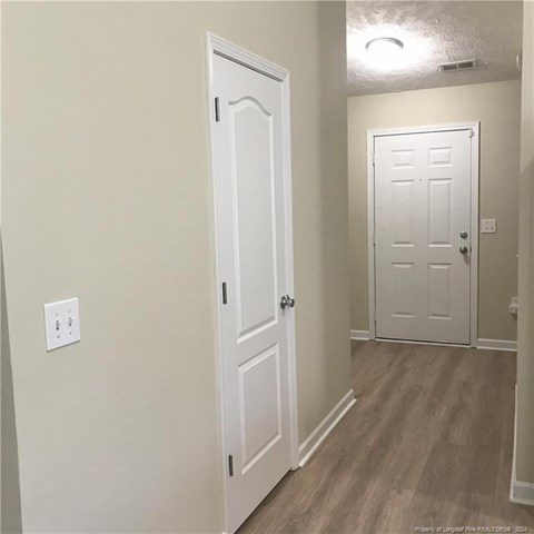A white door is on the left and a white door with a window is on the right.