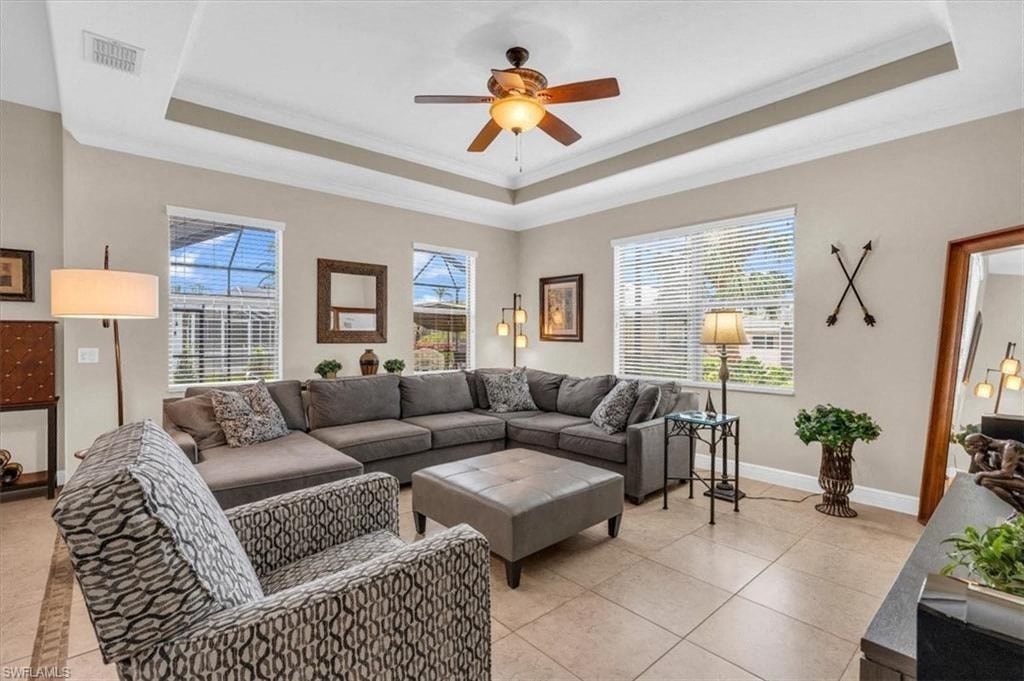 a living room with a couch and a ceiling fan