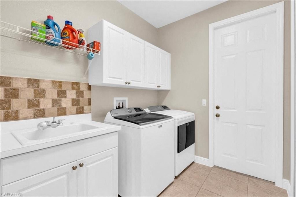 a white kitchen with a stove and a sink