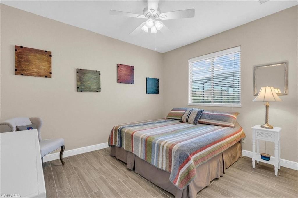 a bedroom with a bed and a ceiling fan