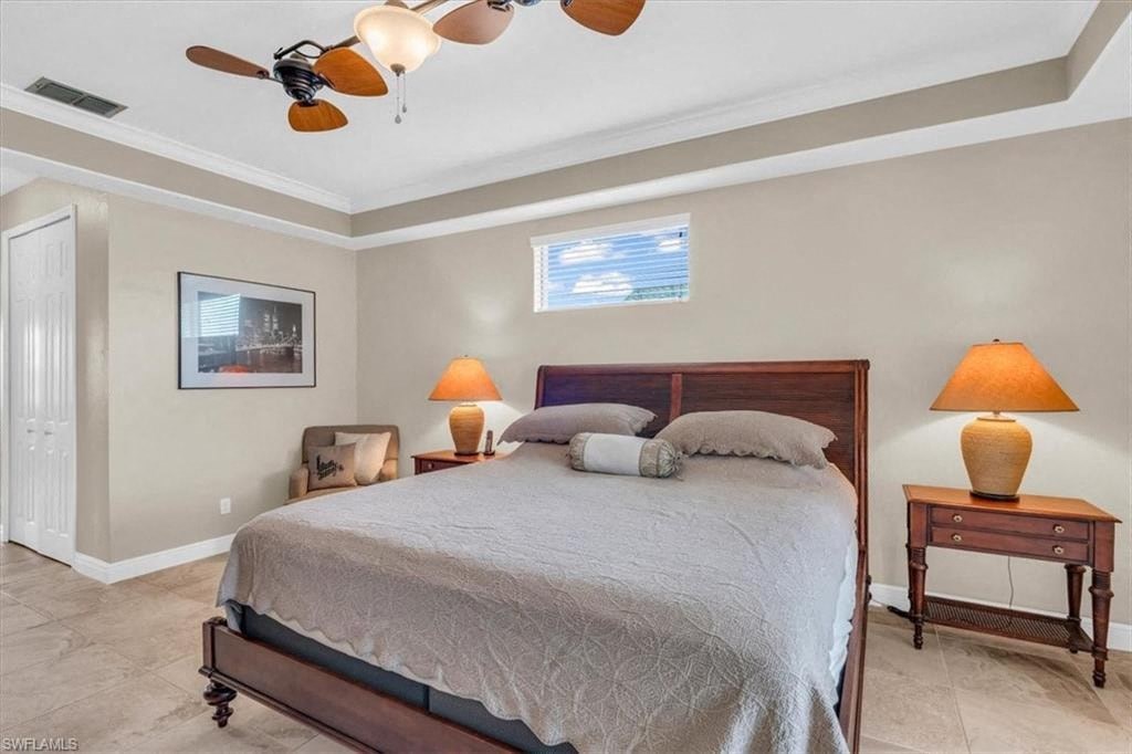 a bedroom with a bed and a ceiling fan