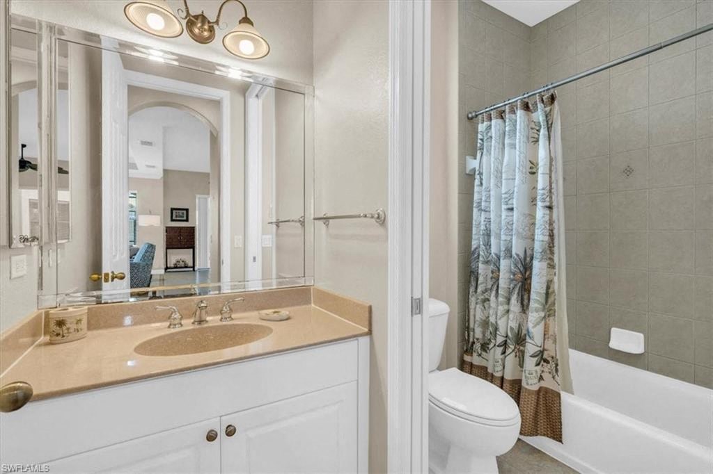 a bathroom with a sink and a toilet and a shower