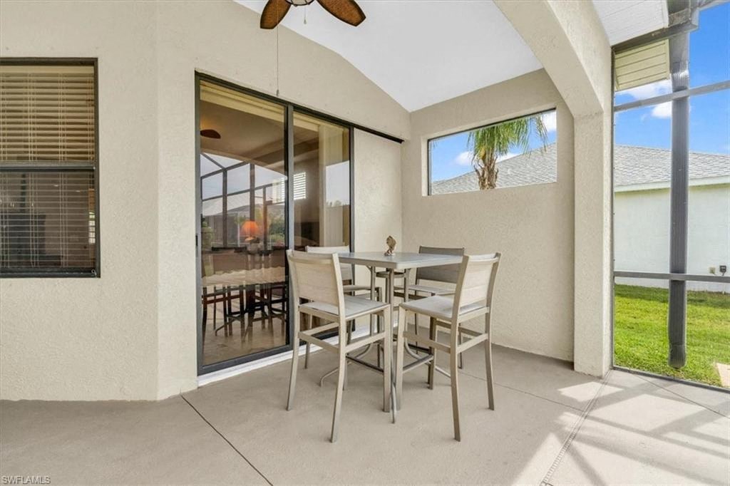 a patio with a table and chairs on it