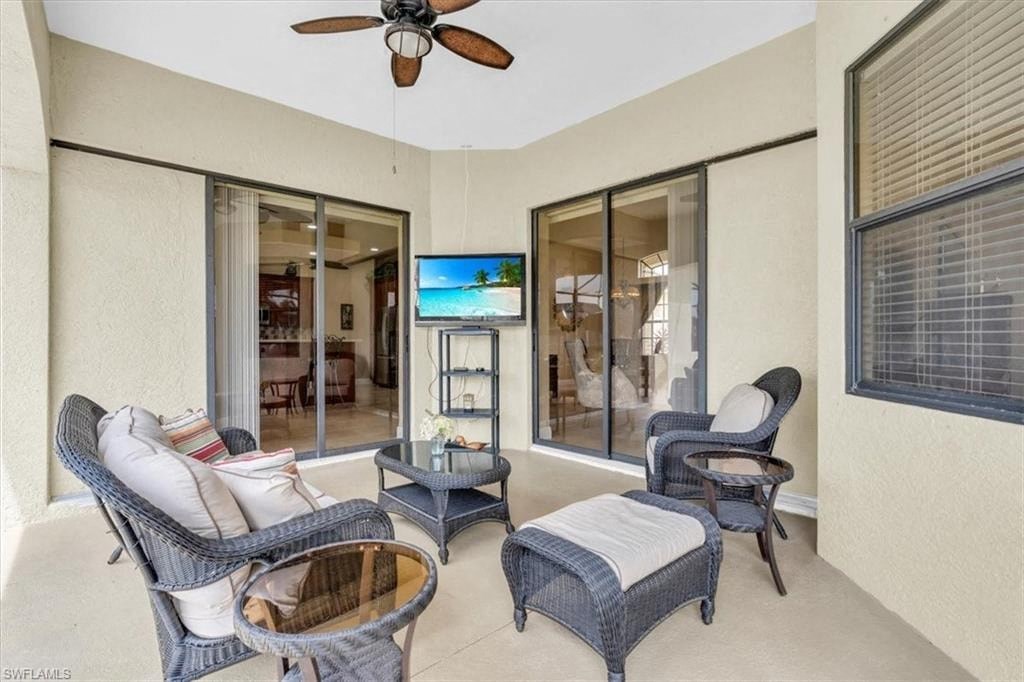 a living room with furniture and a ceiling fan
