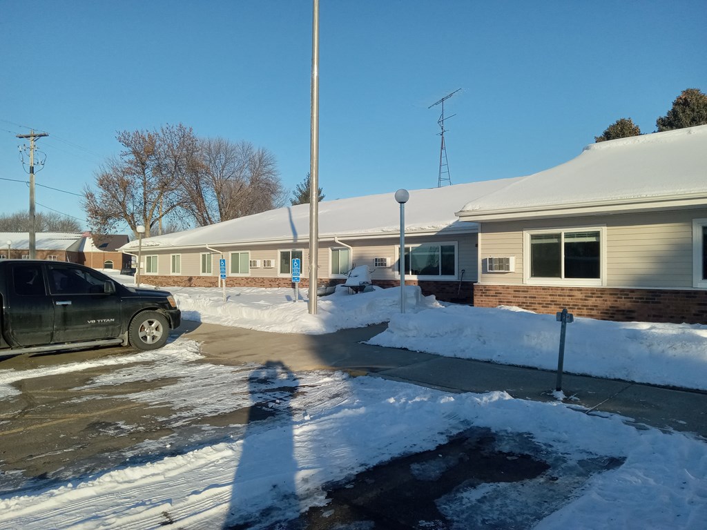 a house with snow on the ground and a car in the driveway