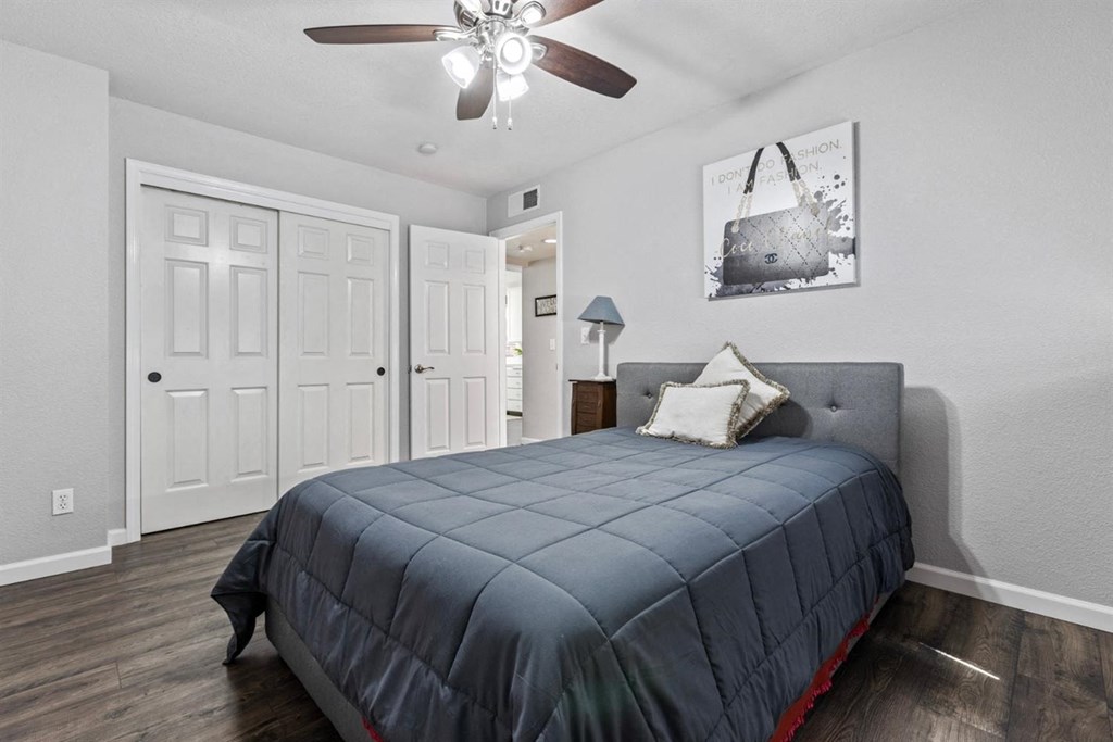 a bedroom with a bed and a ceiling fan