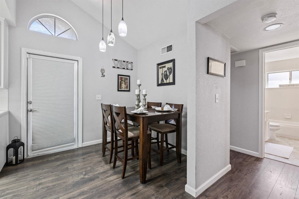 a dining room with a wooden table and chairs