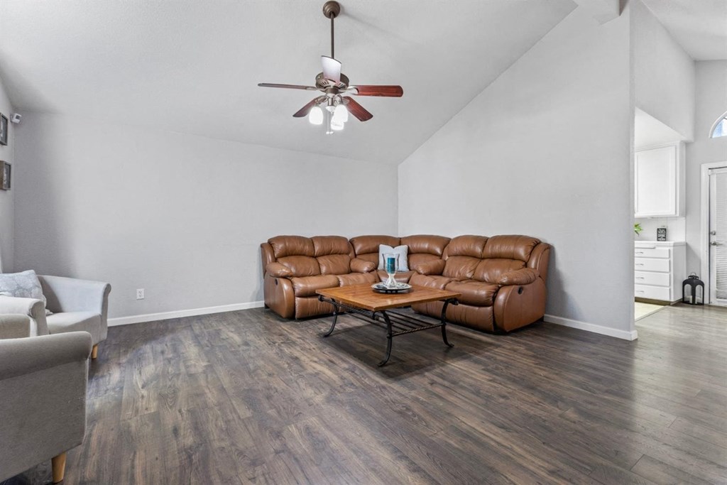 a living room with a couch and a ceiling fan