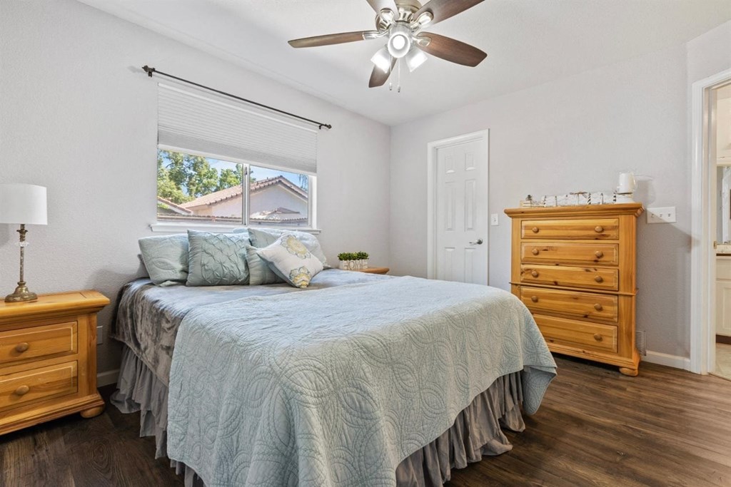 a bedroom with a bed and a ceiling fan