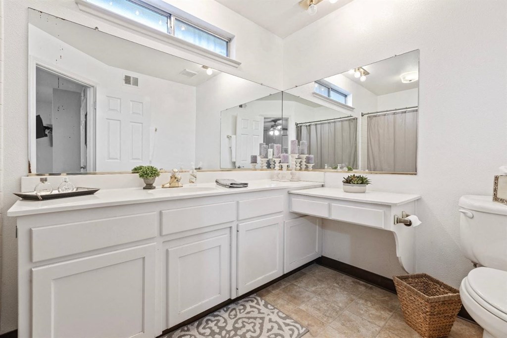 a bathroom with a toilet sink and a mirror