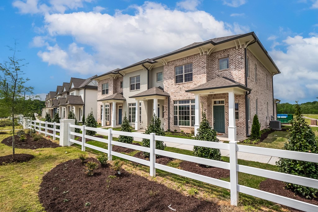 a large house with a white fence in front of it