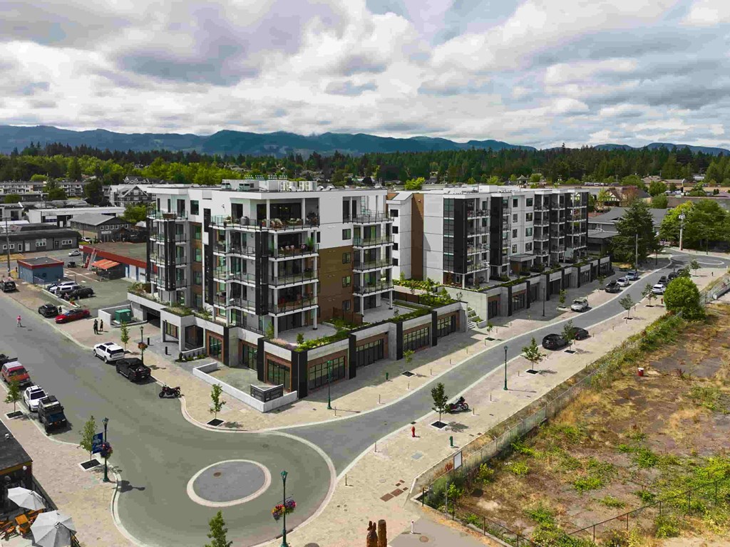 A modern apartment complex with a roundabout in front.