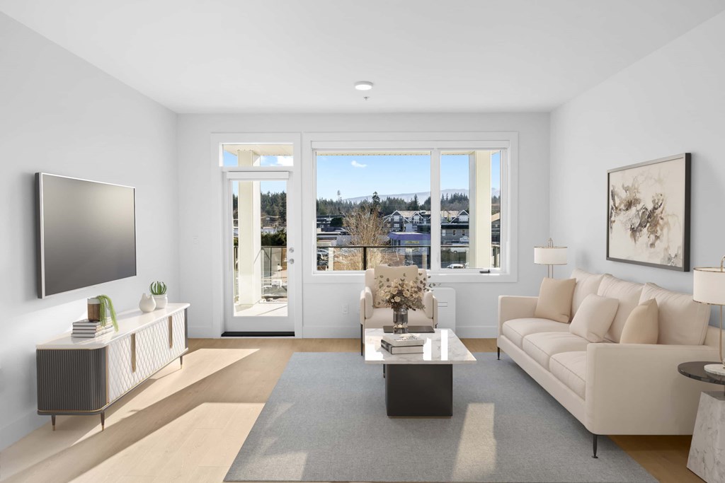 A modern living room with a flat screen TV on the left and a large window with a view of the outside.