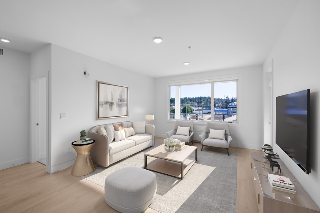 A modern living room with a large window and a flat screen TV.