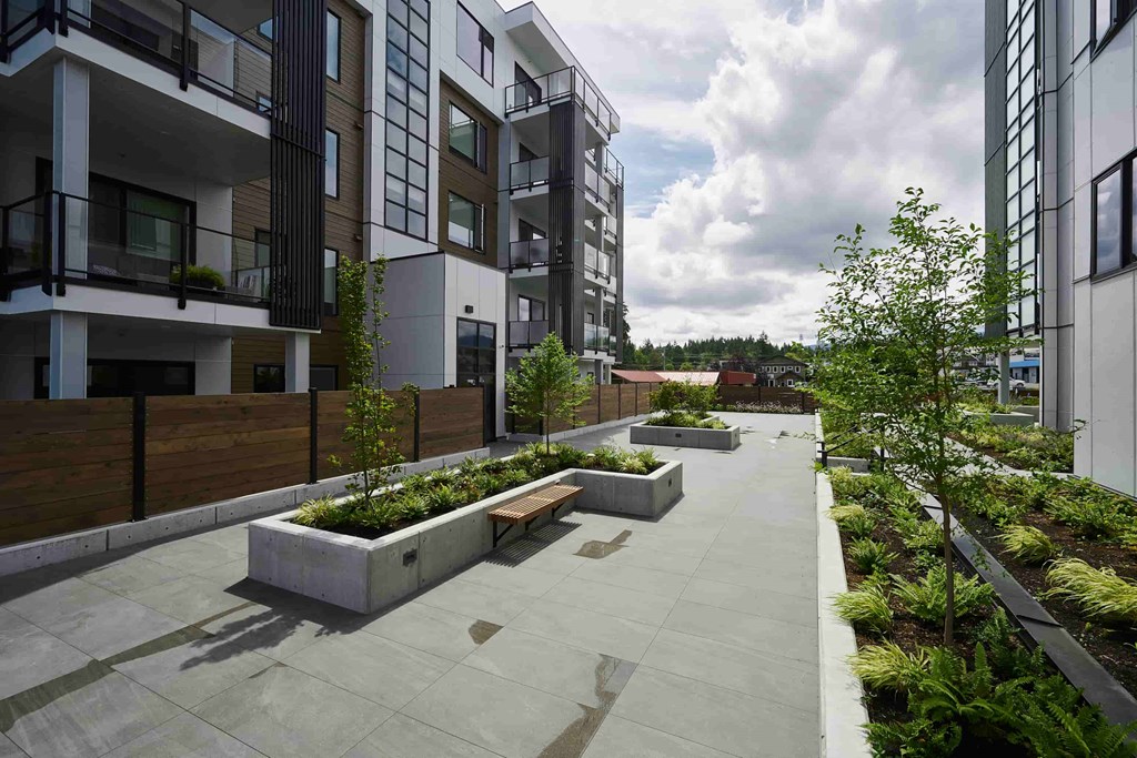 A modern residential area with apartment buildings and a landscaped courtyard.