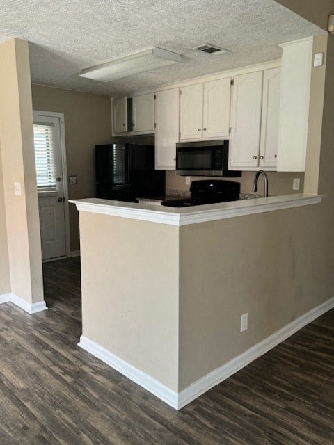 an empty kitchen with a counter and a microwave