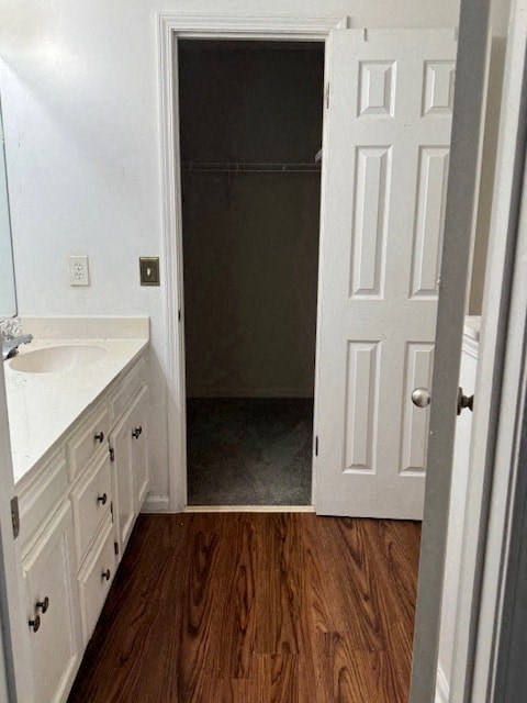 a bathroom with white cabinets and a white sink