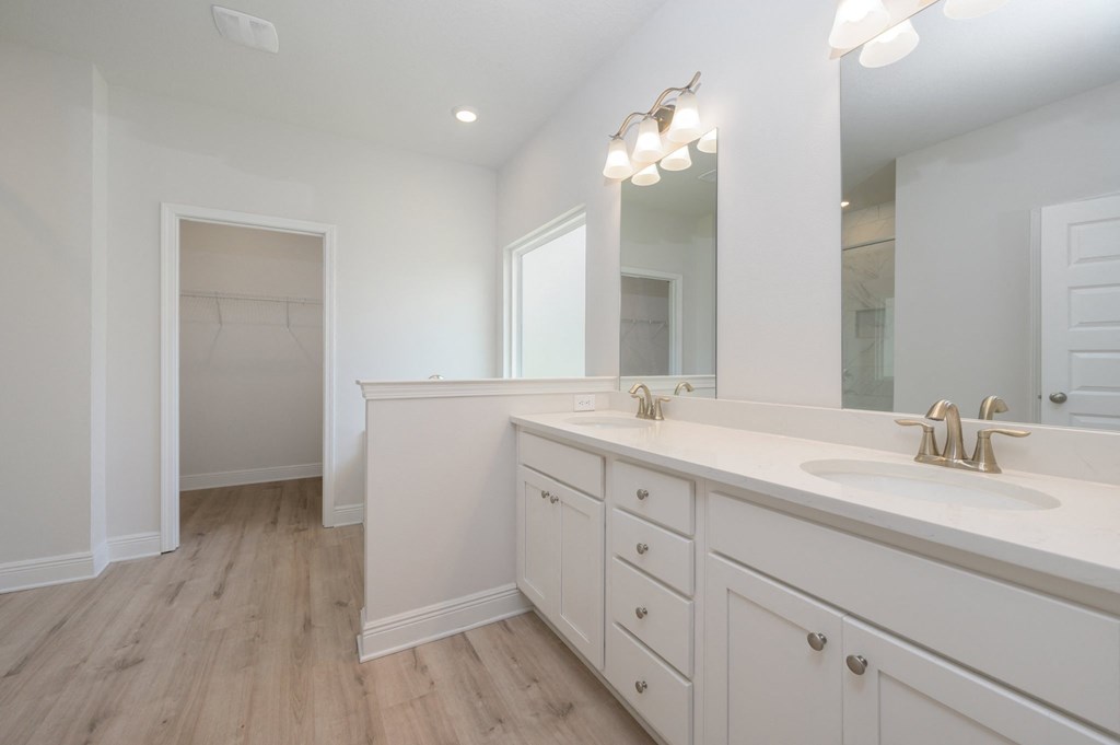 a white bathroom with a sink and a mirror