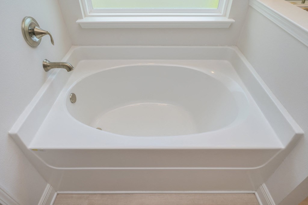 the jacuzzi tub in a small bathroom with a window