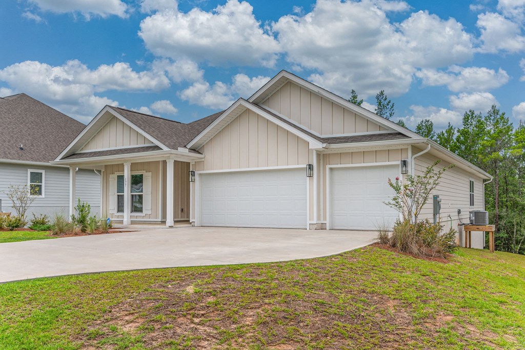 a white house with a driveway and a garage door
