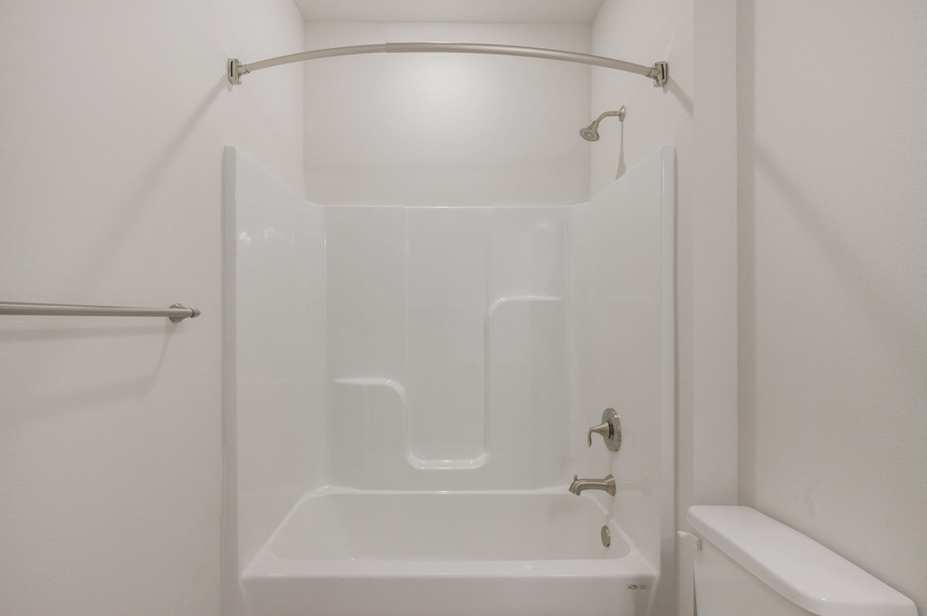 a small bathroom with a shower and a sink