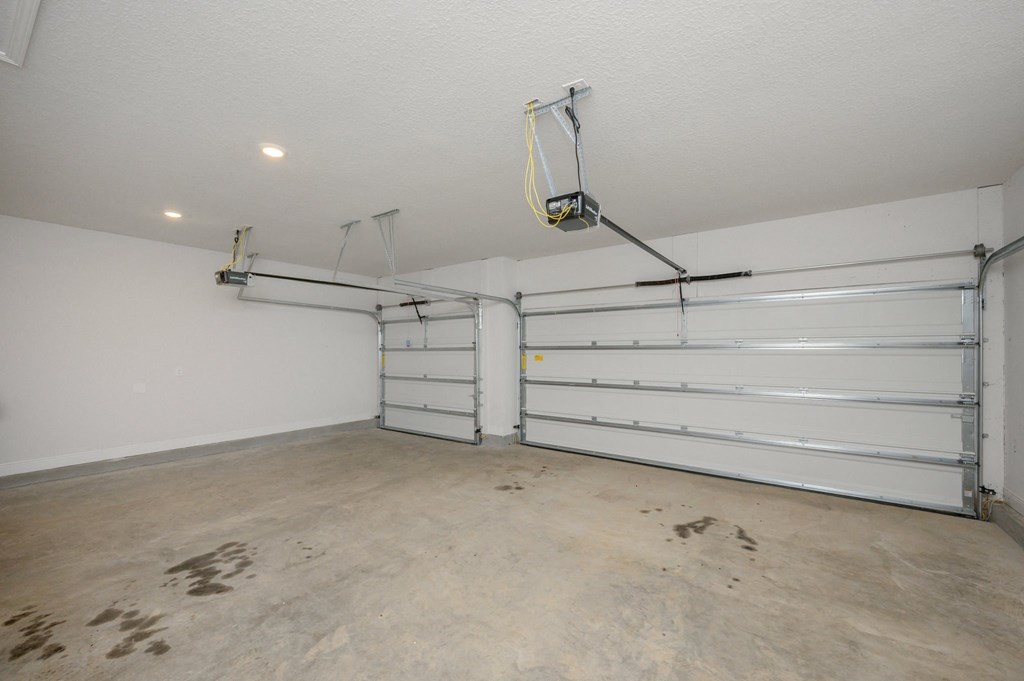 the interior of a garage with white walls and a white door