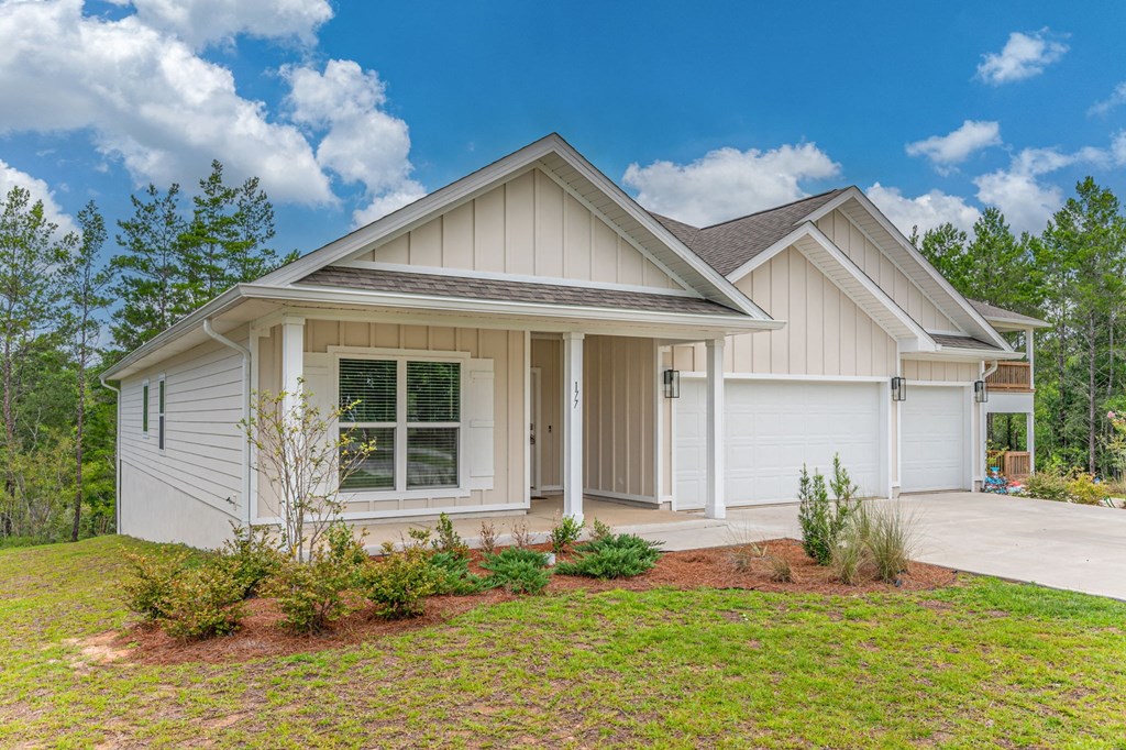 a white house with a lawn in front of it