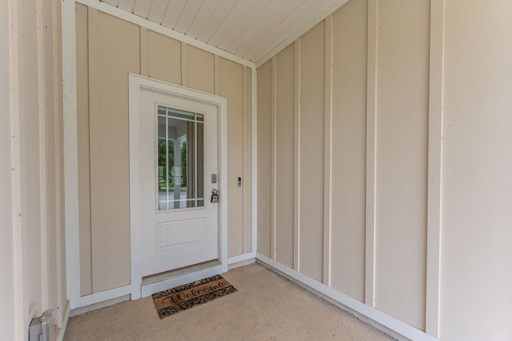 the interior of a home with a white door and white walls