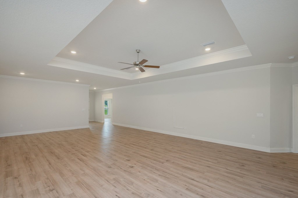 the living room has a hardwood floor and a ceiling fan