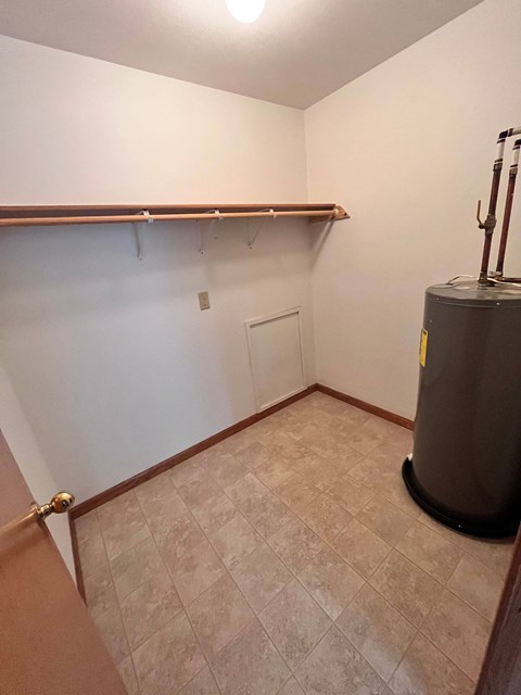 a room with a dryer and a closet in it