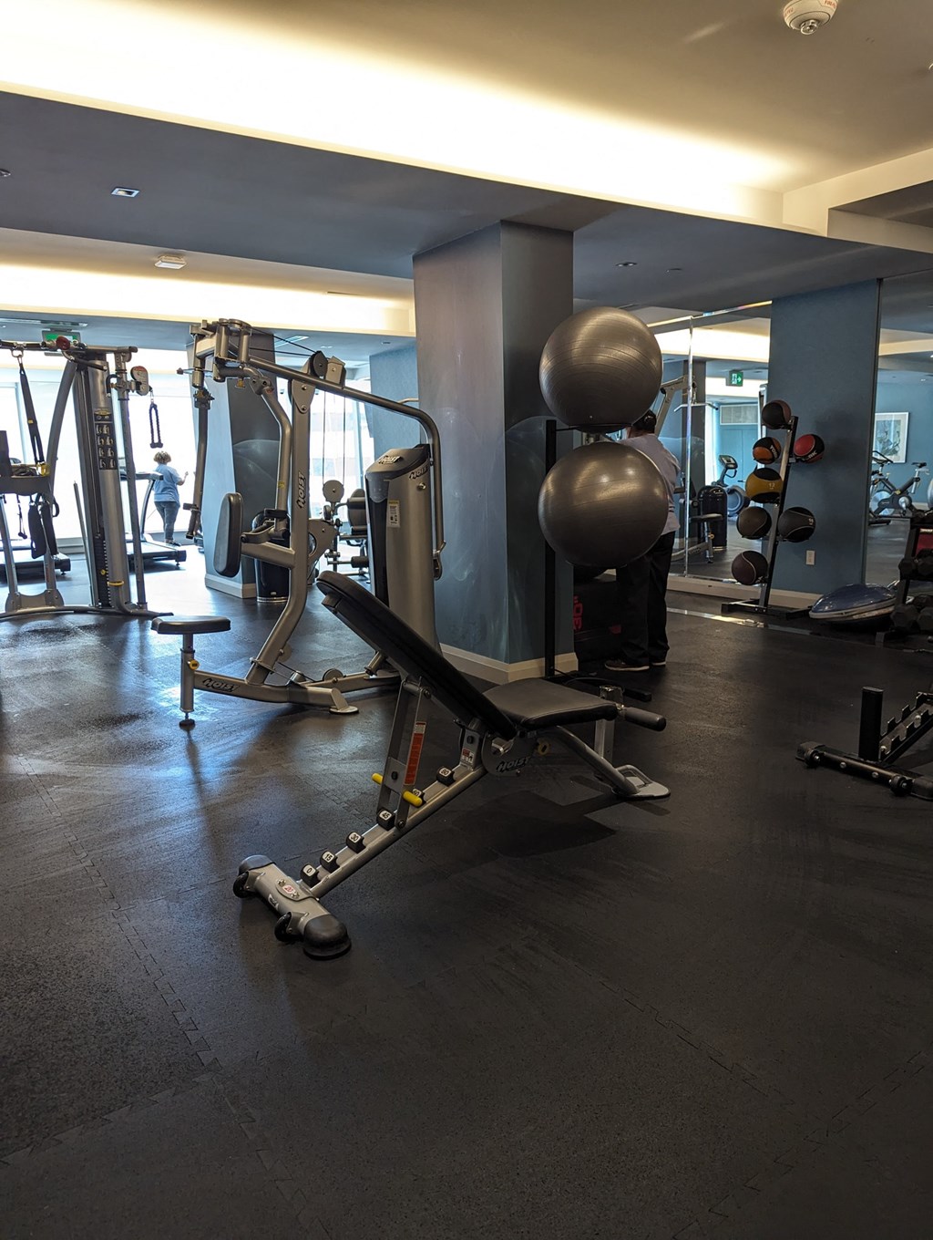 a gym with weights and cardio equipment in a hotel room