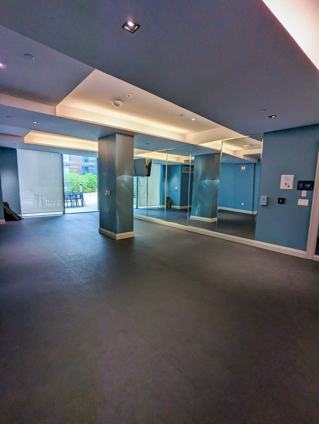 a large empty room in a building with blue walls and a column