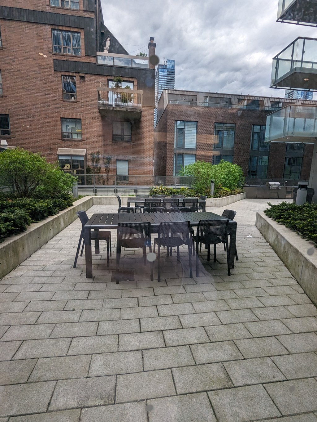 a patio with tables and chairs on a stone patio