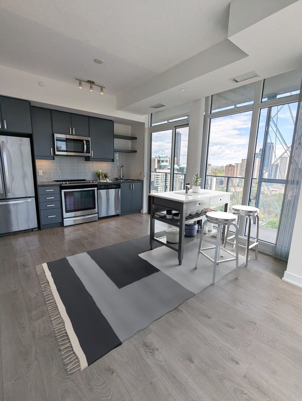 a kitchen with a large rug in the middle of a room