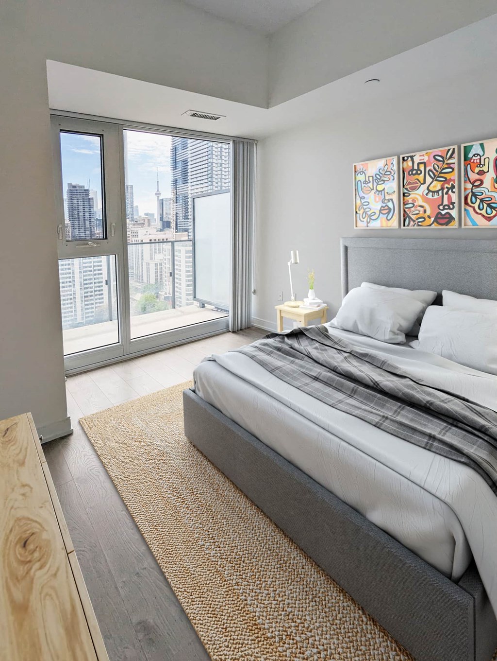 a bedroom with a bed and a large window