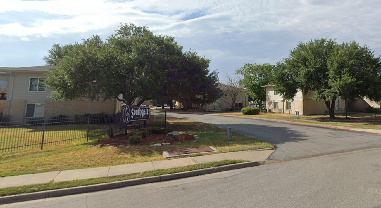 a street with a yard sign in front of a house