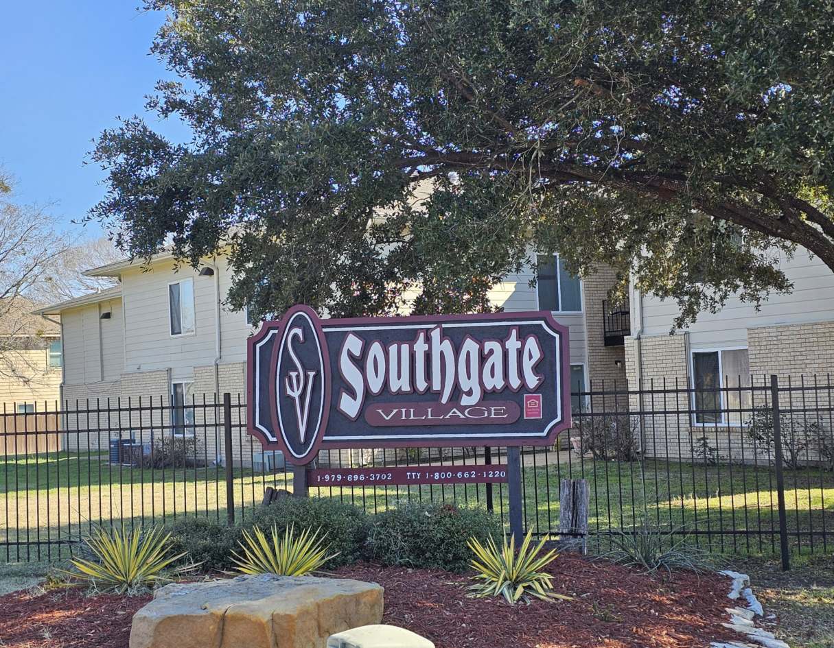 A sign for Southgate Village with a phone number on it.