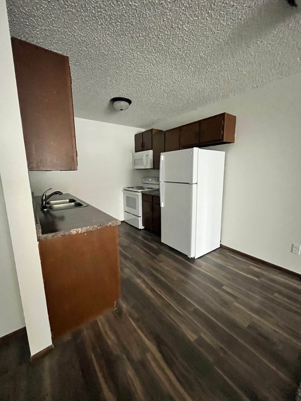 a kitchen with a refrigerator and a sink and a refrigerator