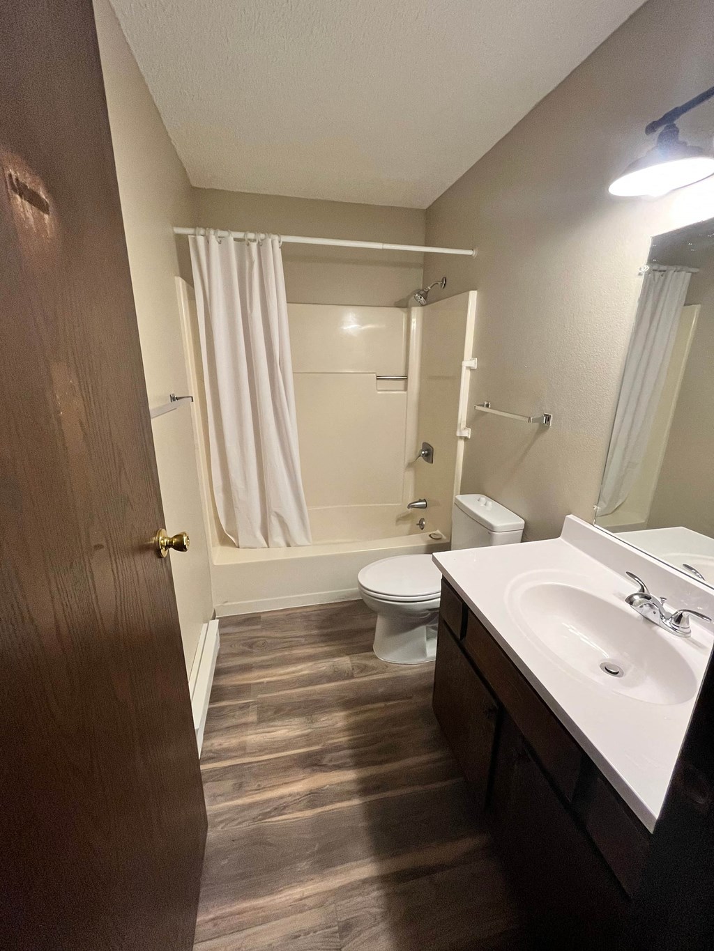 a bathroom with a sink and a toilet and a shower